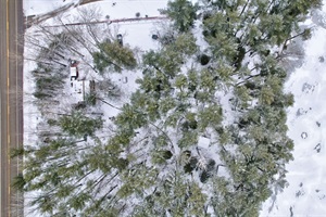 Aerial view of the entire property during winter in Maine. Lakeside on Toddy Pond