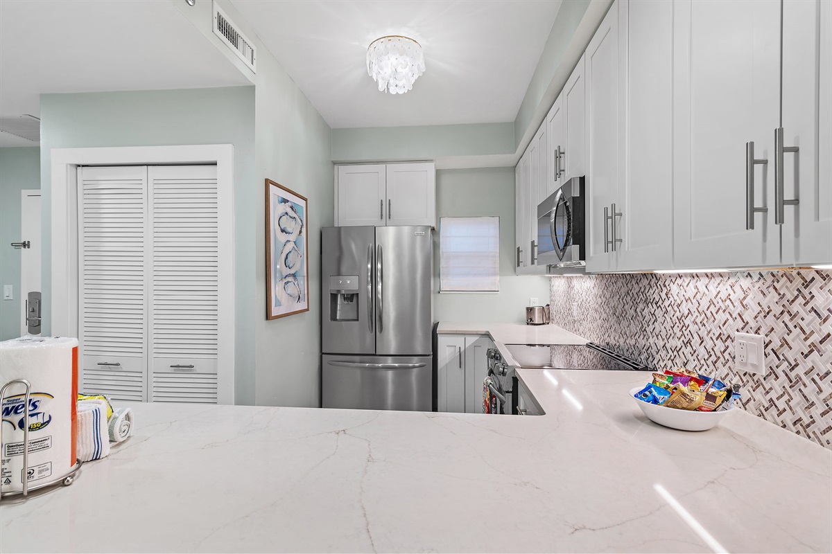 Remodeled Kitchen with new quartz countertops, new stainless steel appliances come fully-stocked for you to prepare meals in your home away from home!