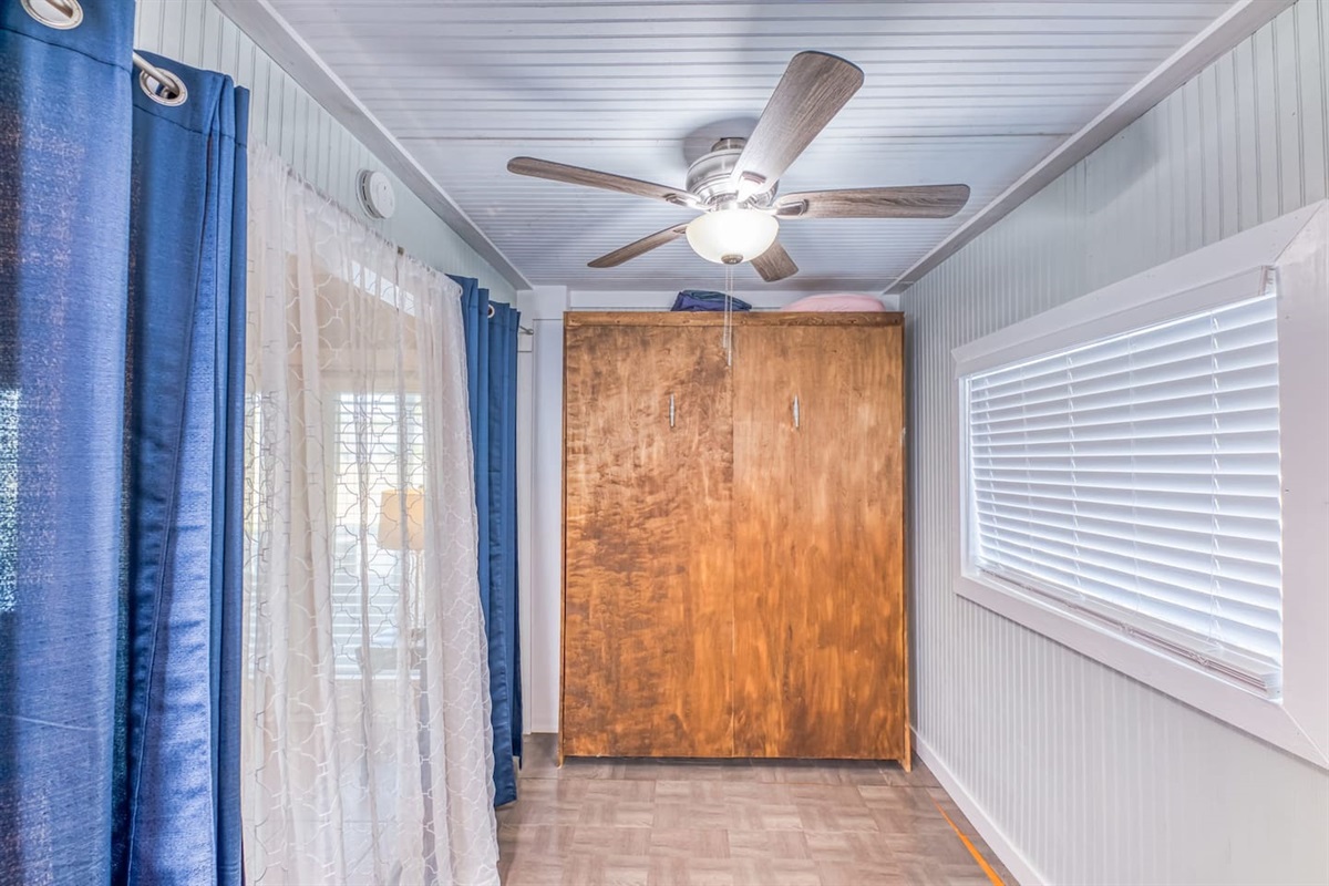 Bright Space: Enjoy light-filled moments in this airy room with queen murphy bed, elegant curtains and charming decor!