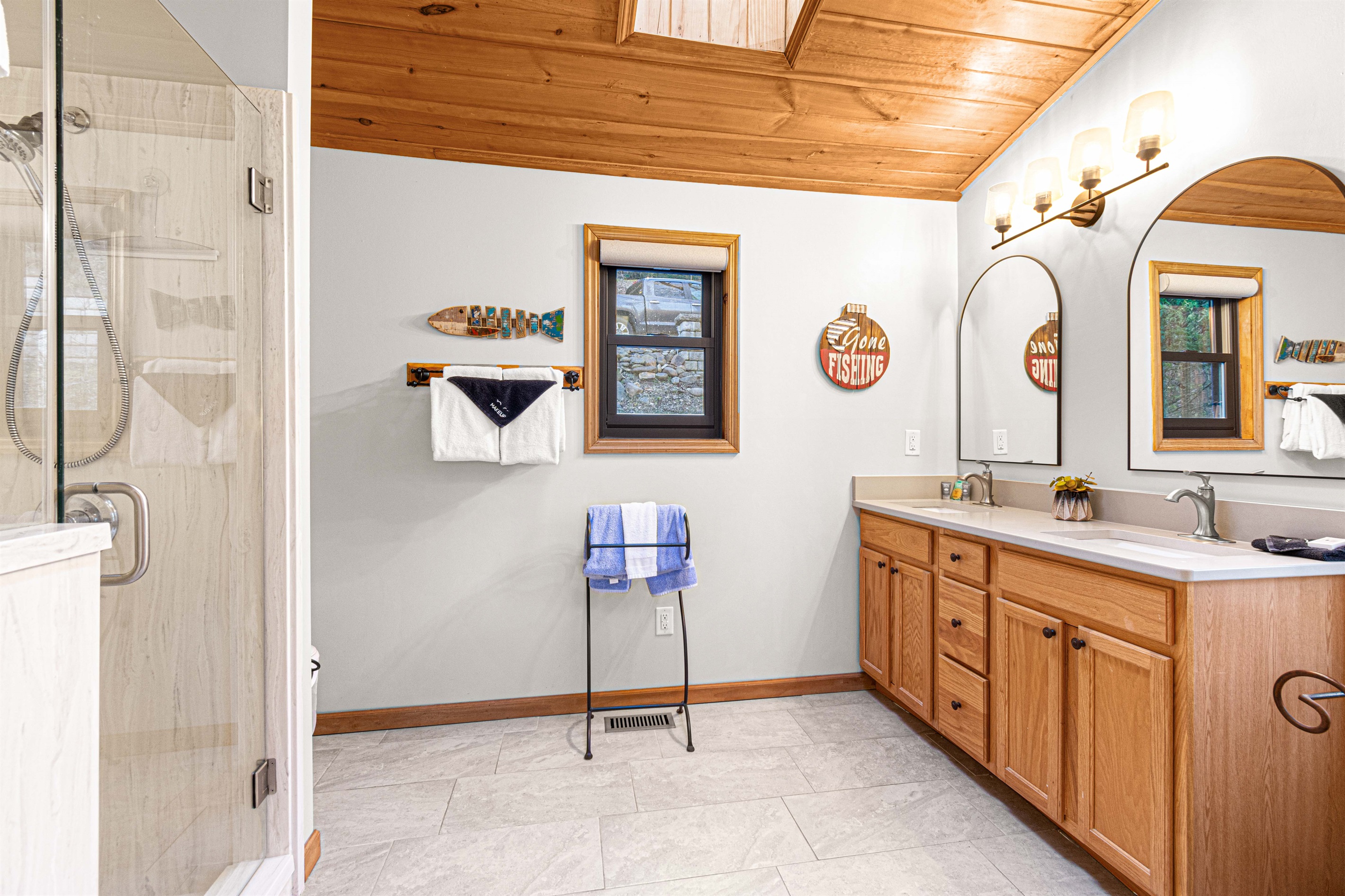 Baths on upper floor have skylights for extra sunlight, all have double vanities.