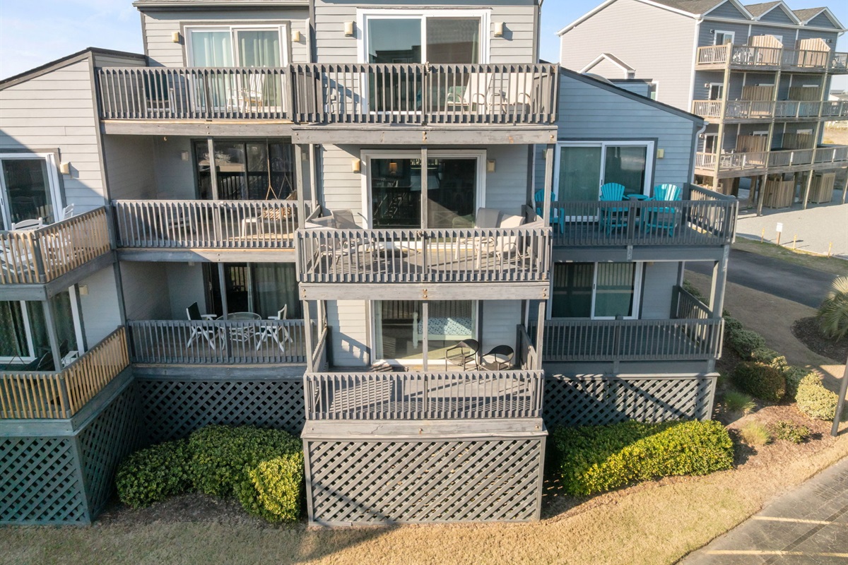 Exterior view of the beachside building with multiple private balconies, located in Shipwatch Condos