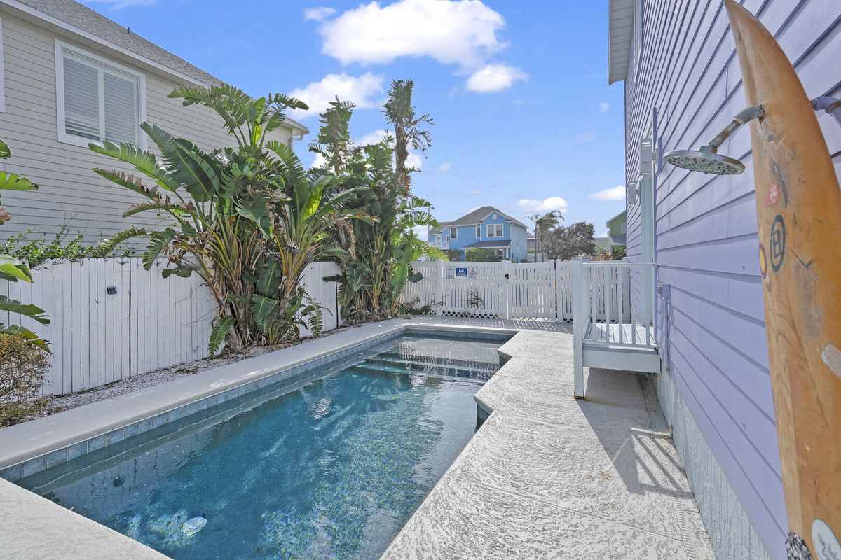 The pool runs the length of the side garden, fenced and private, with the house on one side and planting on the other. Morning laps, afternoon floating, and somebody always in it right up until dinner.