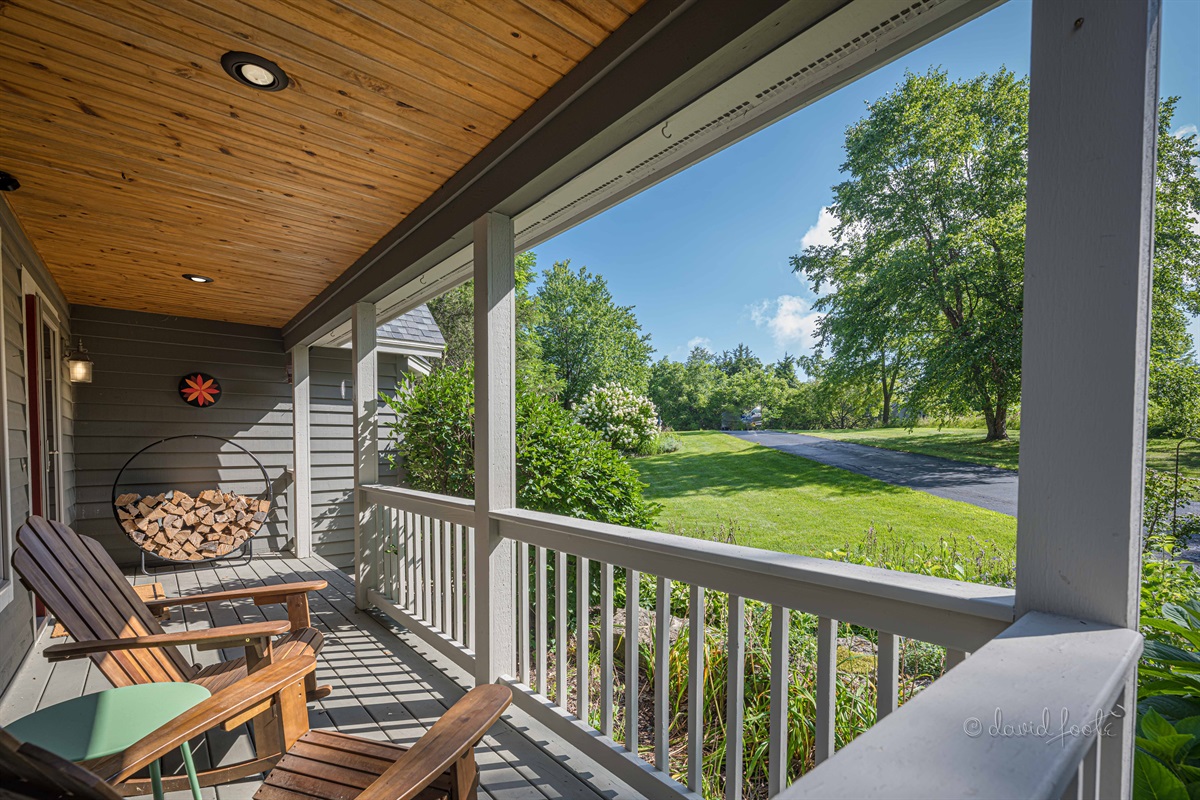 Welcoming front porch with two Adirondack chairs