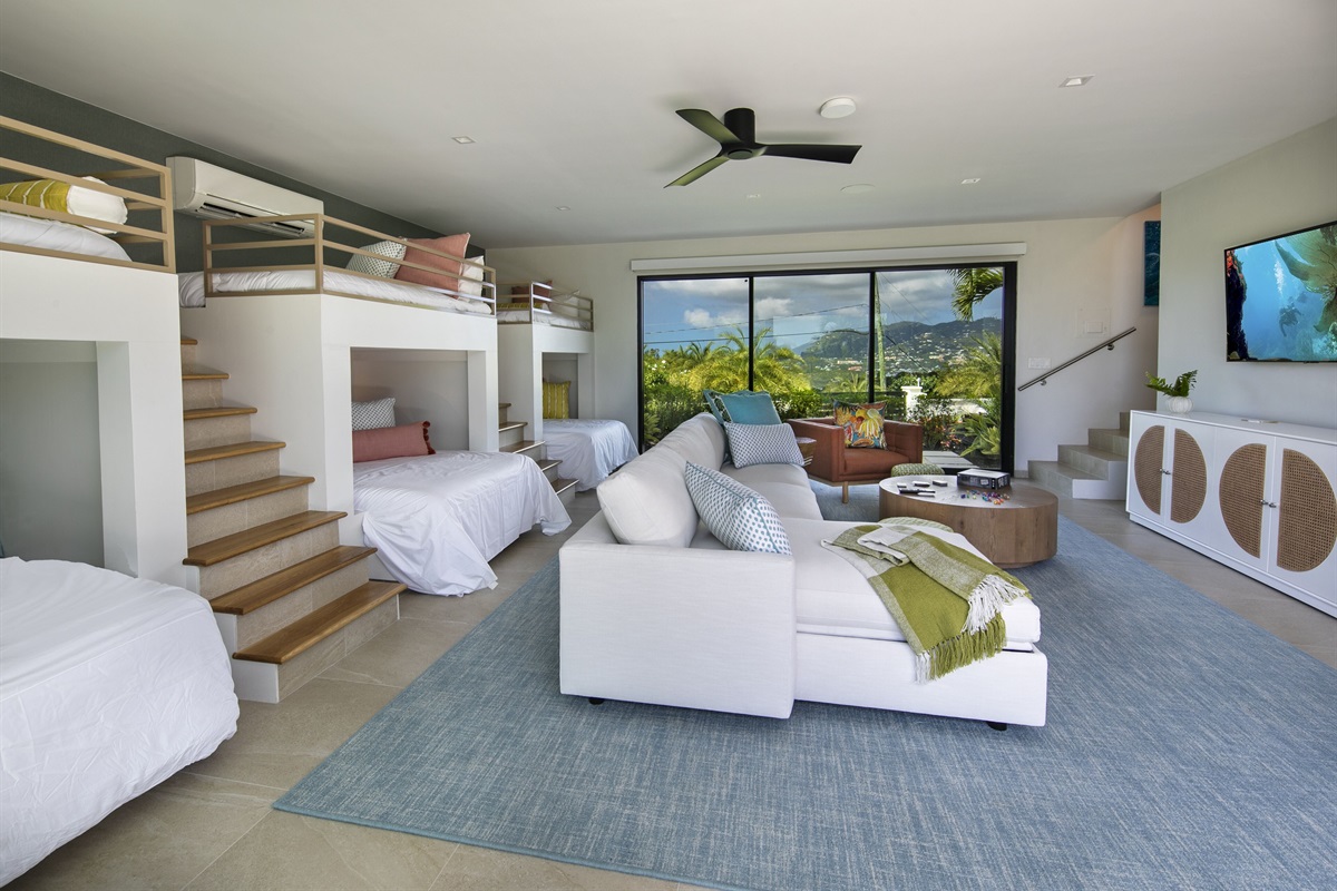 The bunk room has walk out access to backyard as well as the front yard. It is located down a set of interior stairs from the second level of the villa. The staircase is between bedrooms 4 and the second primary bedroom.