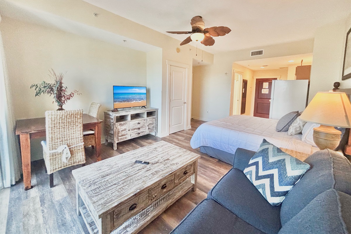 Spacious living/dining room area with TV