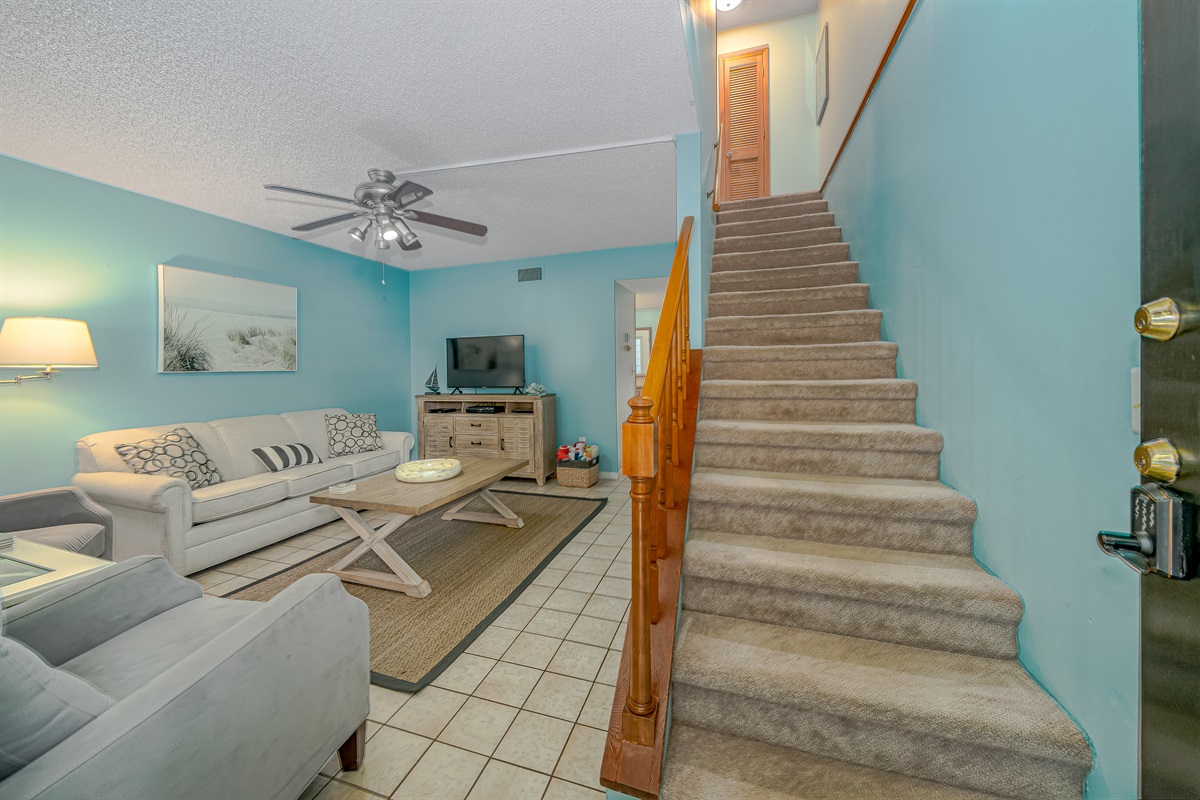 Living Room with Smart TV and Staircase to Bedrooms