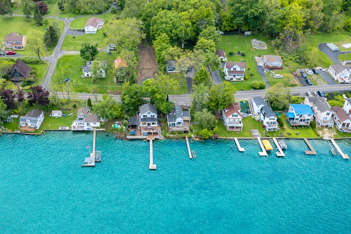 Aerial shot showcasing expansive lakefront entertaining space, hot tub, and private dock for the ultimate getaway 🎯🌊🍹