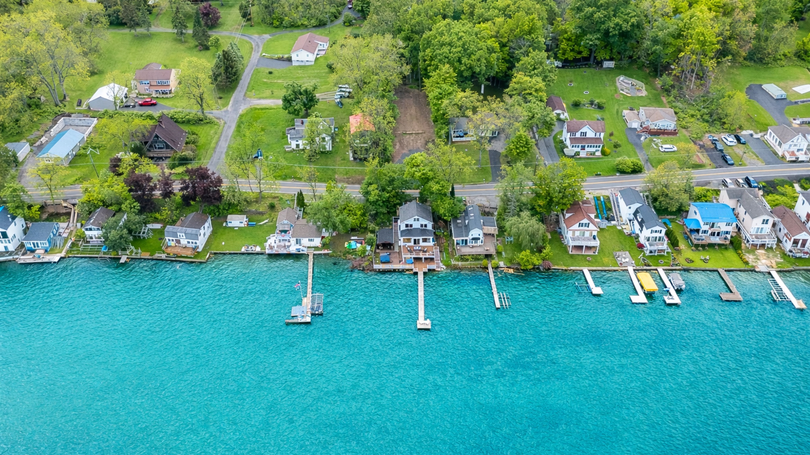 Aerial shot showcasing expansive lakefront entertaining space, hot tub, and private dock for the ultimate getaway 🎯🌊🍹