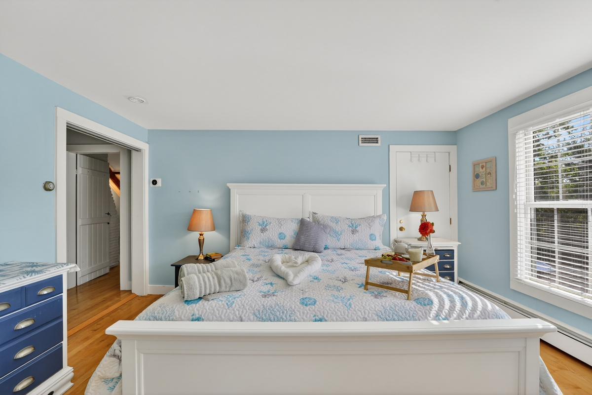 Bright and airy bedroom with comfortable furnishings and plenty of space to relax.