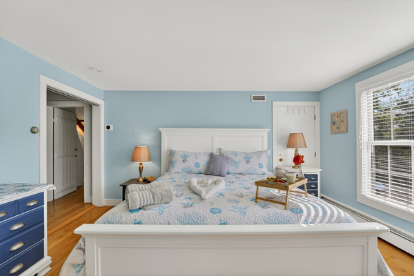 Bright and airy bedroom with comfortable furnishings and plenty of space to relax.