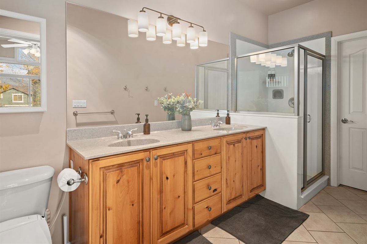 Bright primary bath with dual sinks, walk-in shower, and plenty of space to unwind.