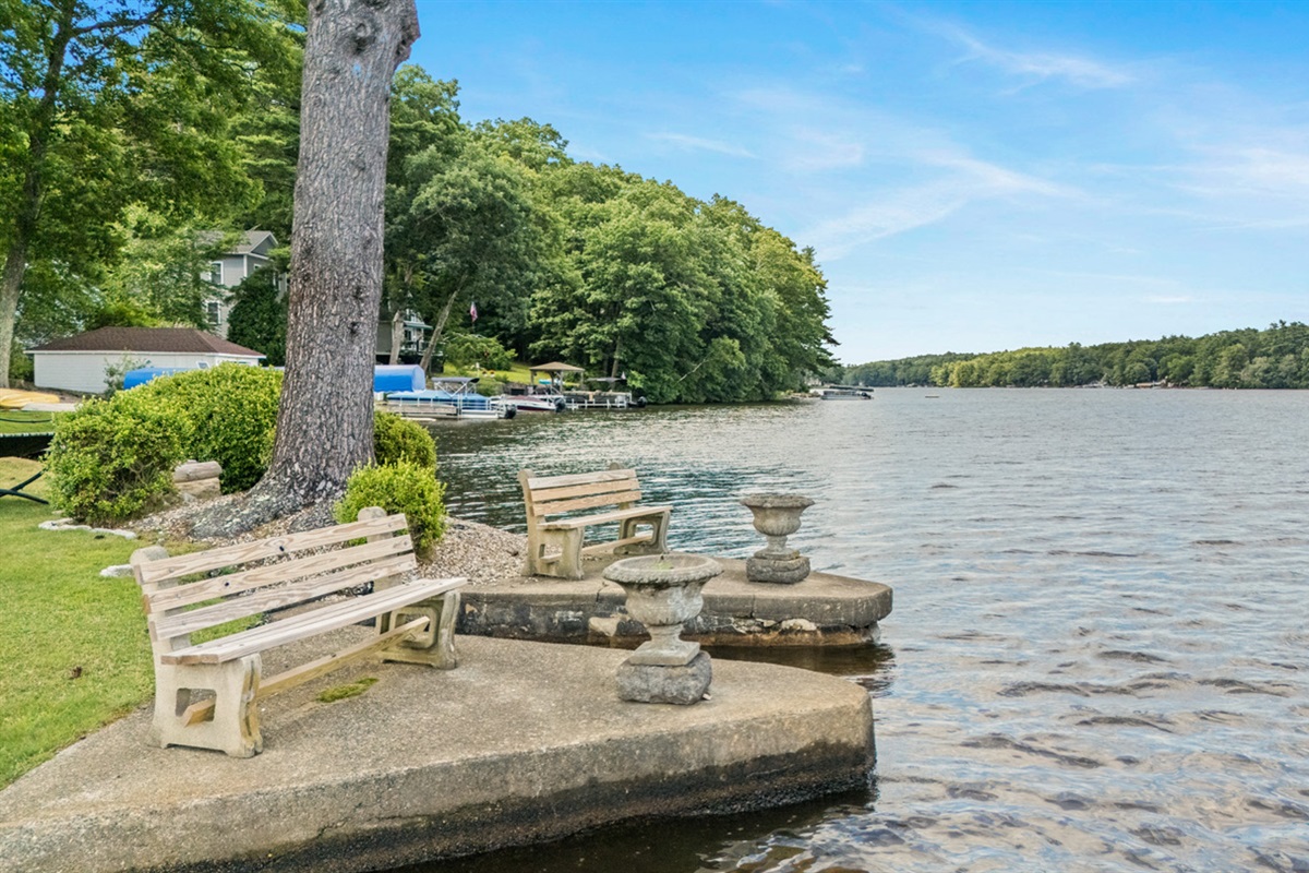 Lake entrance and seating area near the fire pit