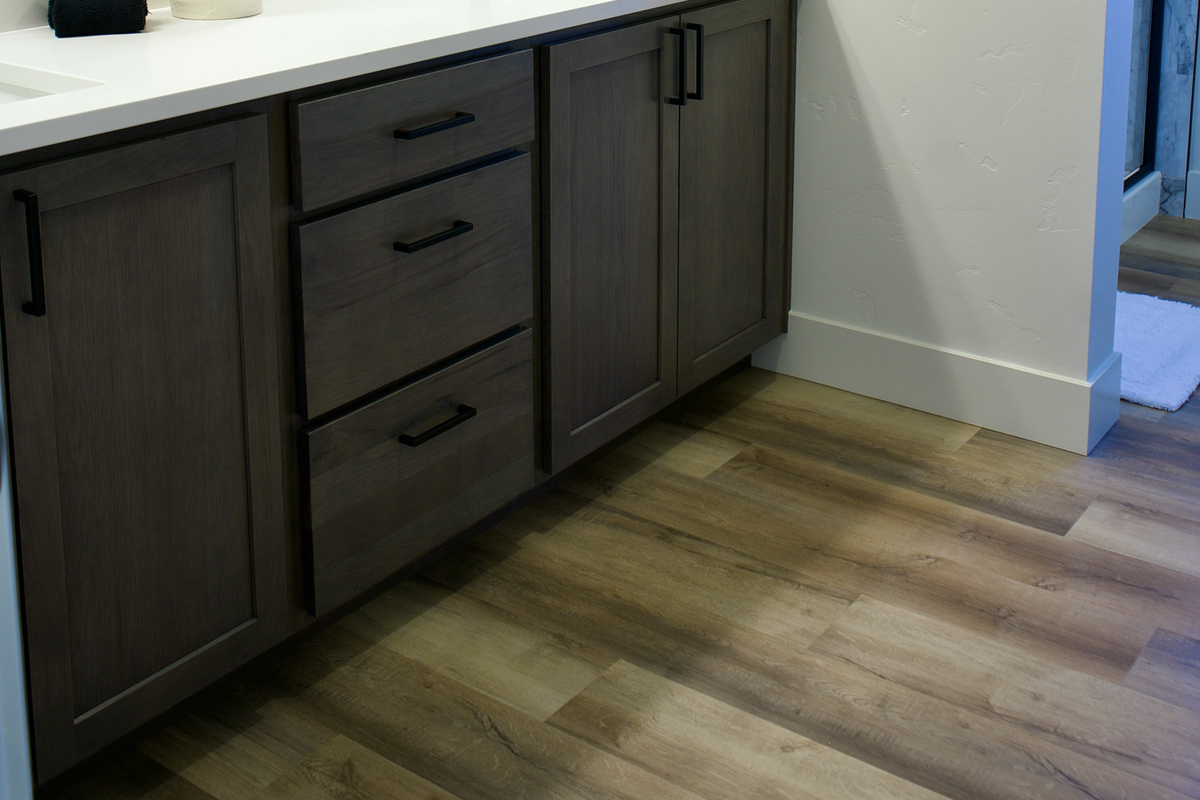 The second upstairs bathroom features a shower and bathtub combination, along with updated finishes and dual sinks, offering both convenience and a modern, functional design.
