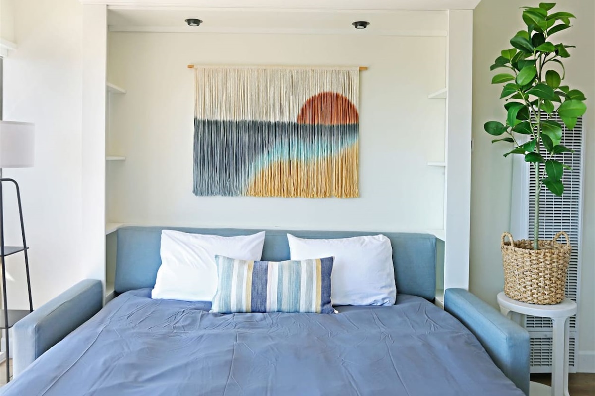 King-sized sofa murphy bed expanded. This bed is every bit as comfortable as a traditional bed with a premium mattress. This King murphy bed enables this one-bedroom condo to accommodate up to four people comfortably.