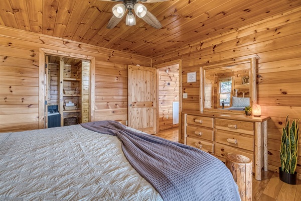 Main-level master bedroom includes a king bed, a private full bathroom, and mountain views! The screened-in patio is right off the master bedroom. 