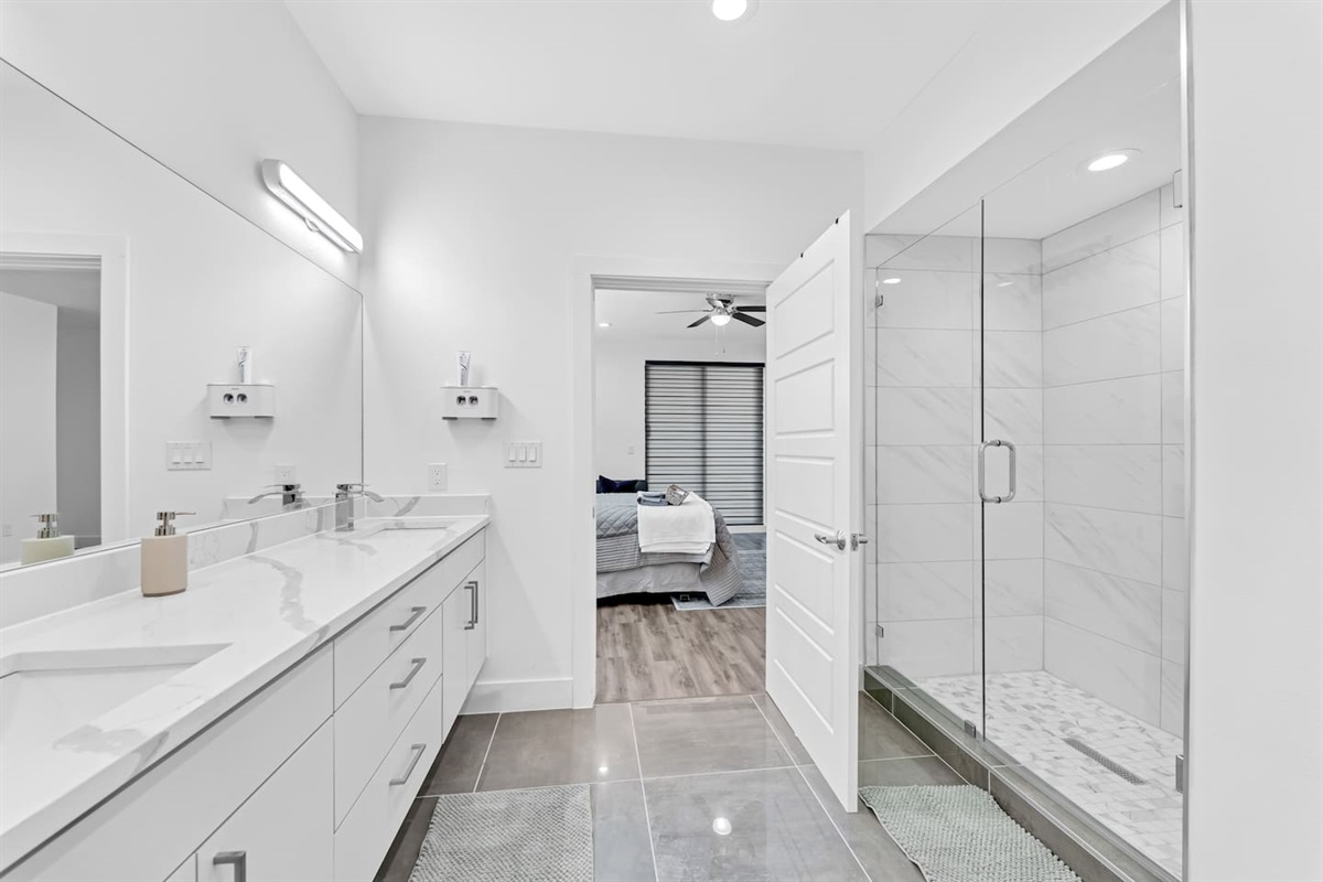Spa-inspired bathroom with dual vanities and bold modern finishes.