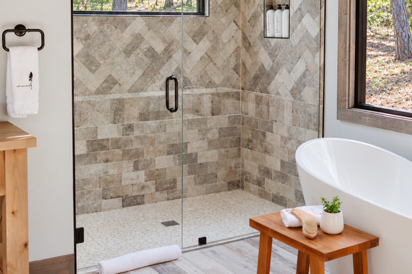 Spa-style bathroom with a soaking tub and forest views.