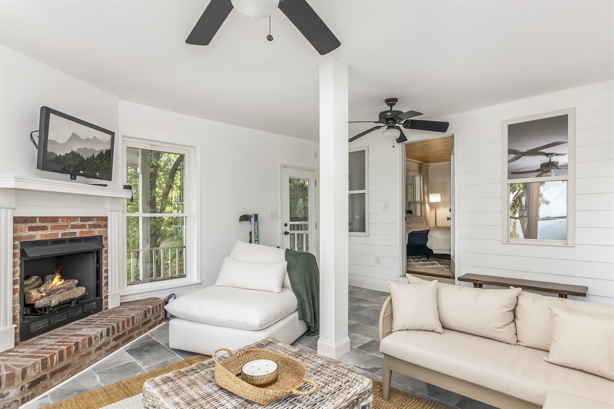 Secondary living room in basement w/ fireplace and smart TV