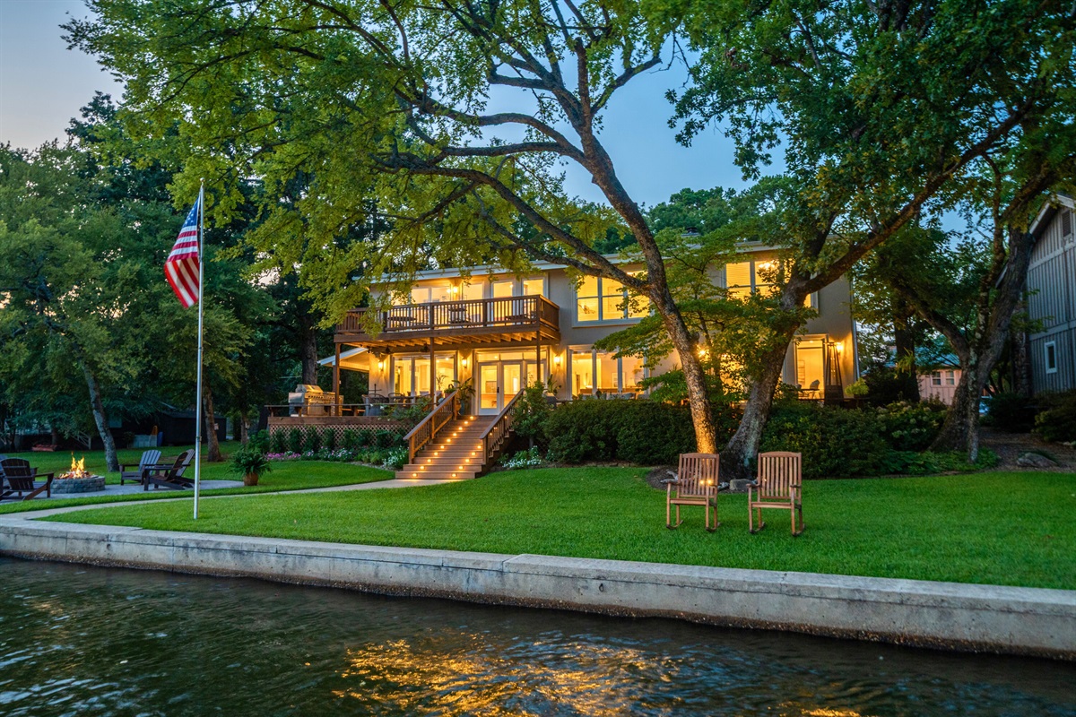 The home lights up beautifully at dusk &mdash; welcoming you back after a day of lake adventures.