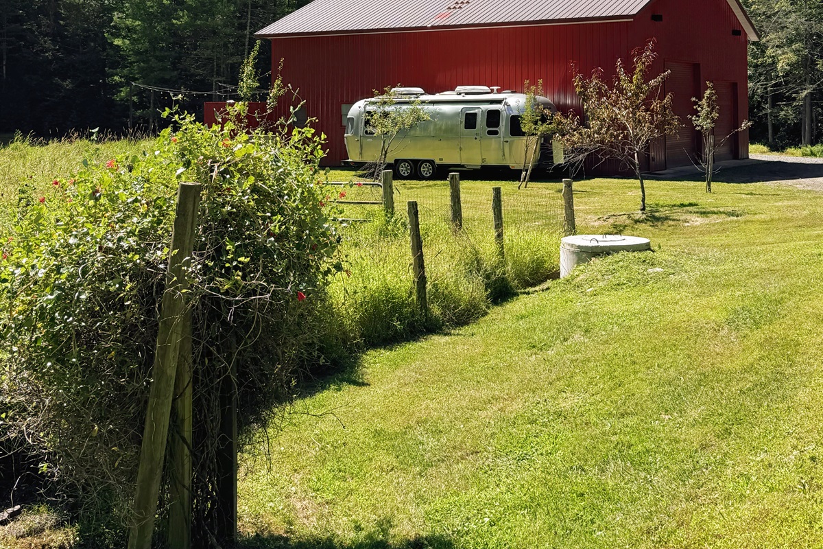 Exterior approach. Entry is around the right side of the barn, in the rear.