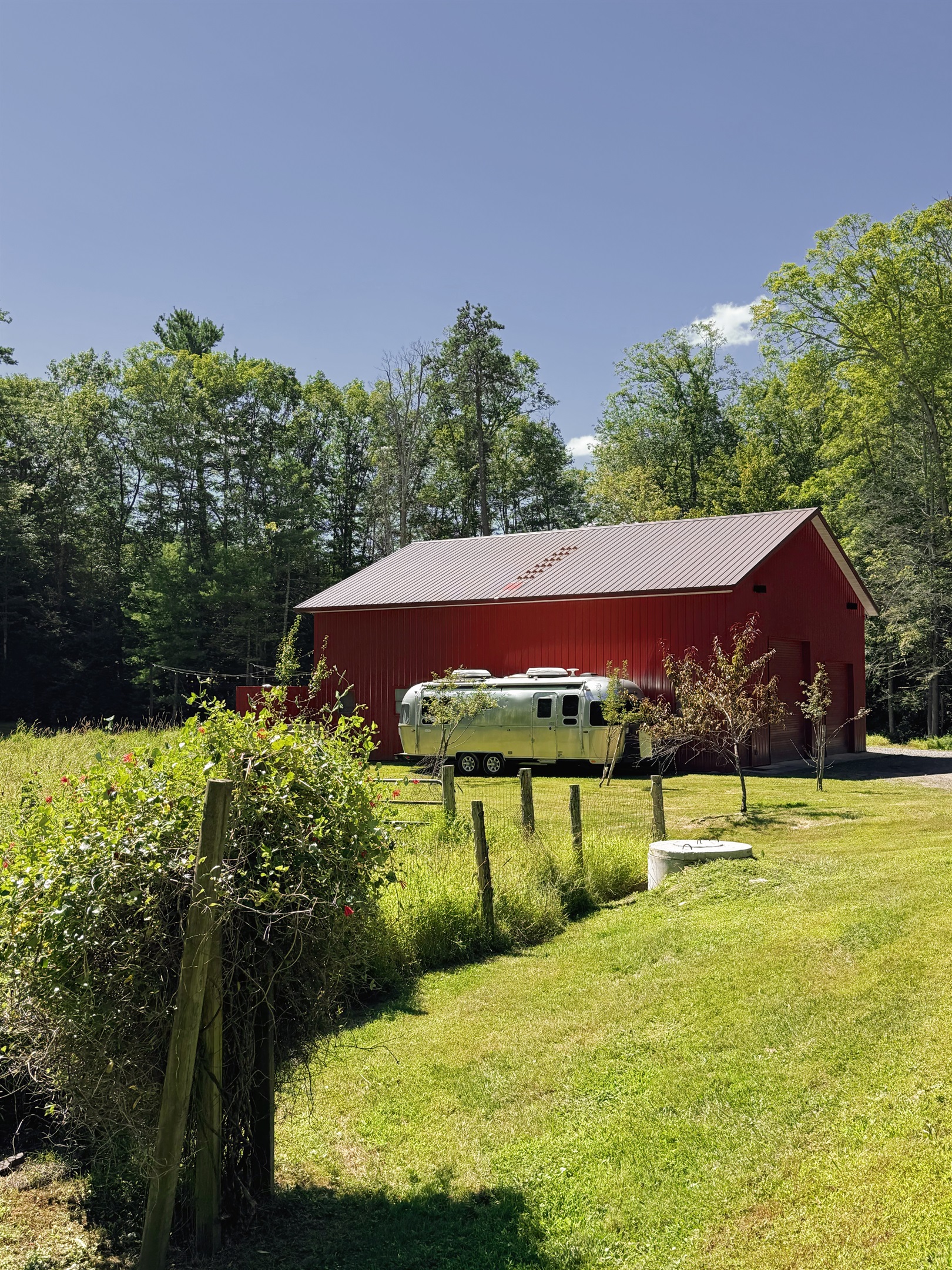 Exterior approach. Entry is around the right side of the barn, in the rear.