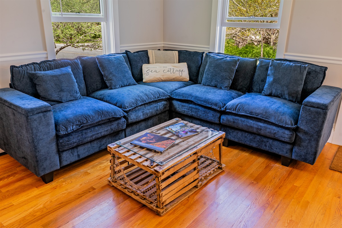 Relaxed 1880s elegance. Our main living area features a new navy sectional and a 55-inch Roku TV. The perfect spot to gather by the electric fireplace and stream your favorite shows after a day on the Quiet Side trails.