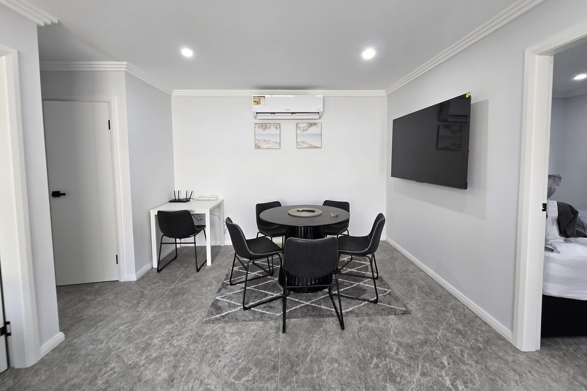 The dining area brings together meals, screen time and a small workspace in one tidy, open section of the home.