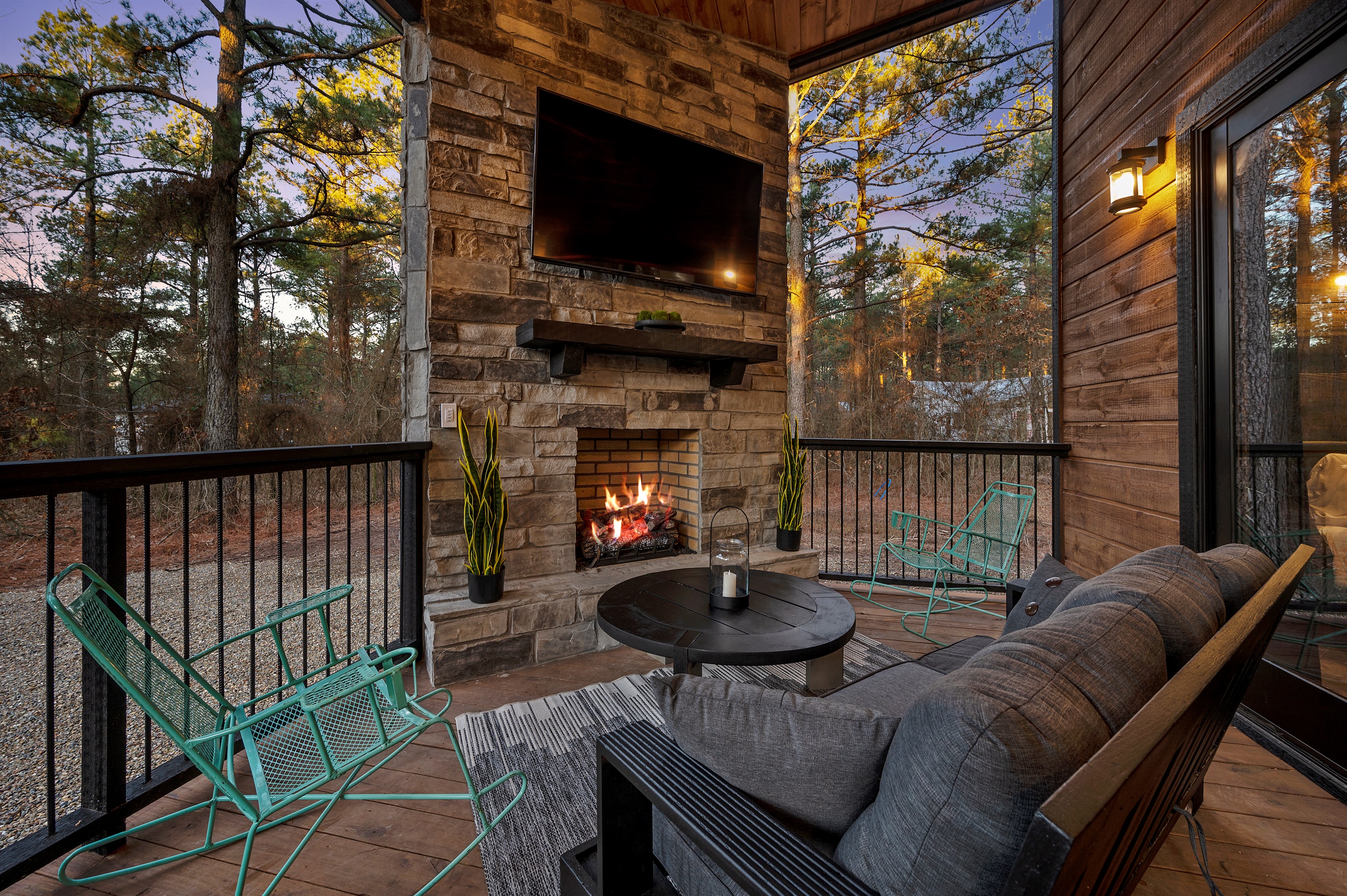 Cozy up by the outdoor fireplace as the sun sets through the trees.