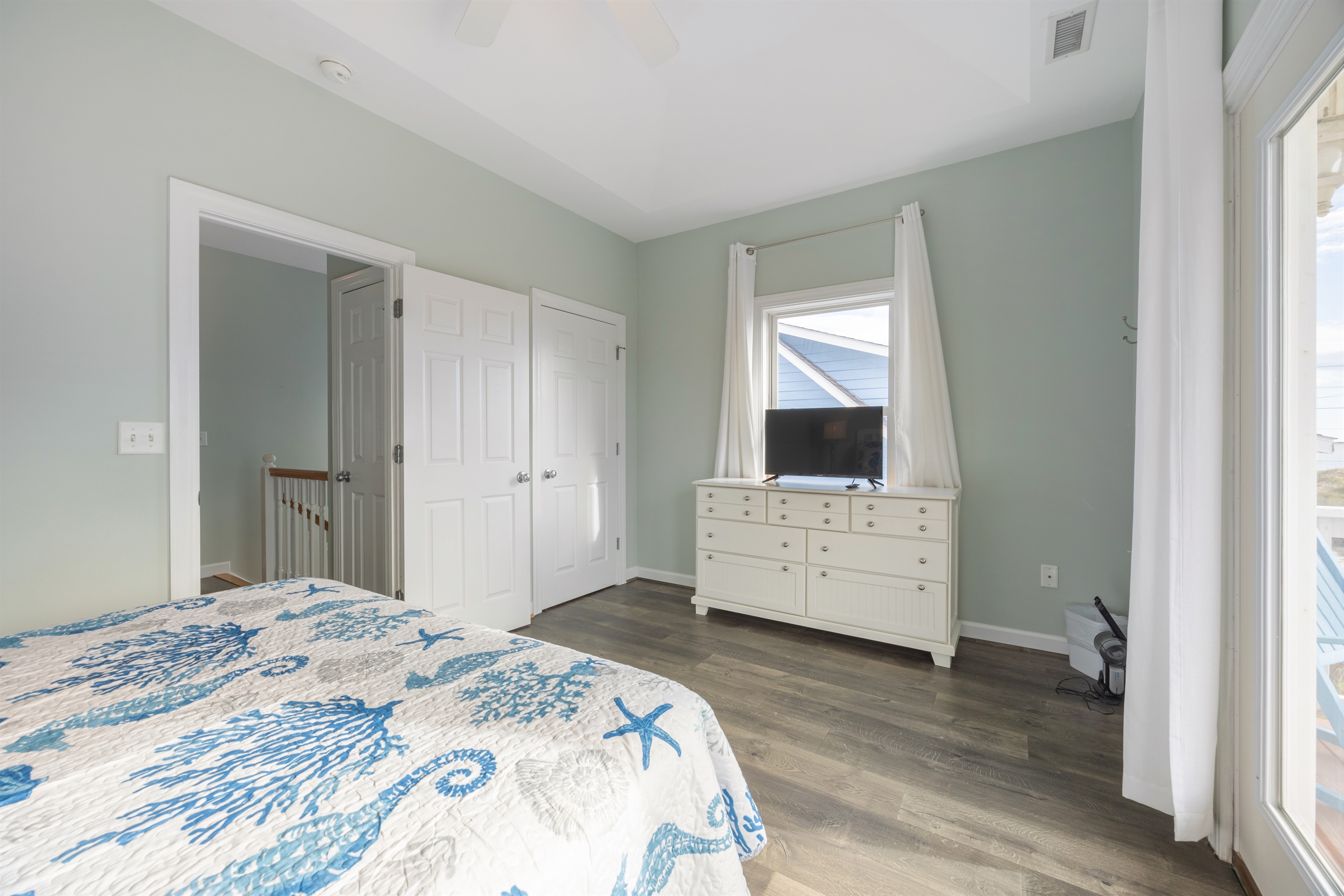 This queen bedroom includes a TV, closet. and dresser for easy entertainment and storage