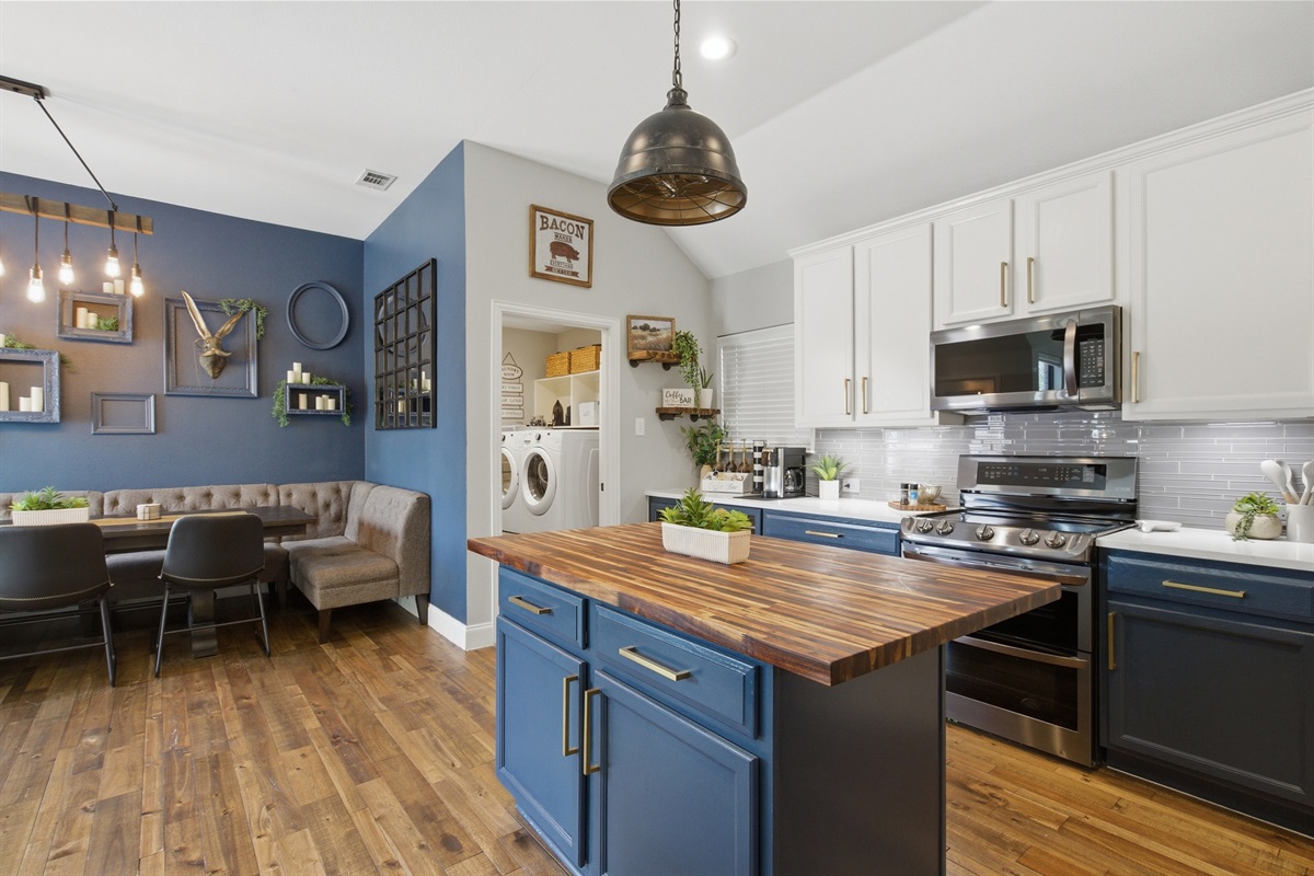 Galley-style view of the Kitchen featuring the LG Refrigerator, full prep counter space, and pendant lighting overhead. Plenty of room to cook for the whole group.
