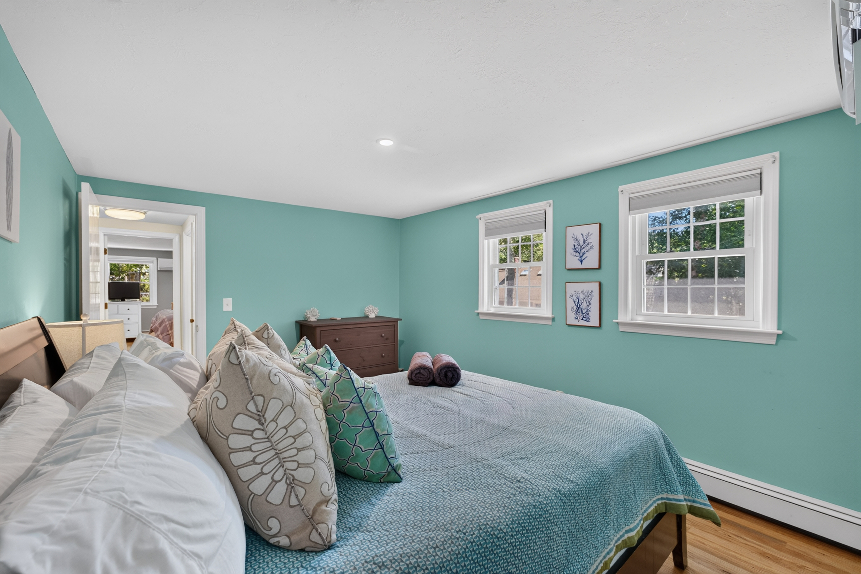 Bright, inviting bedroom with thoughtful touches and plenty of natural light.