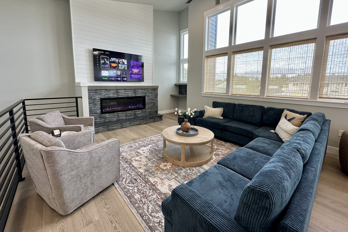 Back upstairs, the fireplace and the big screen make the great room the natural landing spot at the end of a beach day.