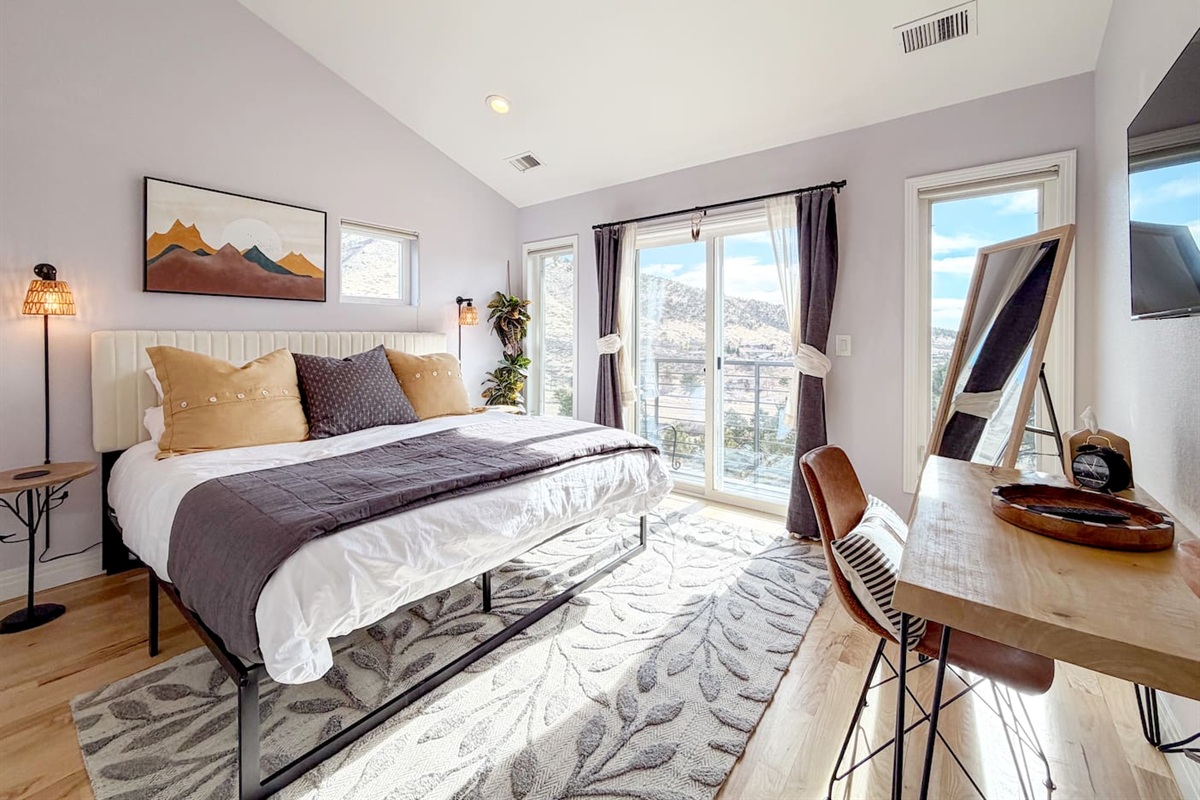 This bright king bedroom is filled with natural light and mountain views, with a private balcony just outside the door—the perfect spot to enjoy a quiet morning coffee or take in the sunset.