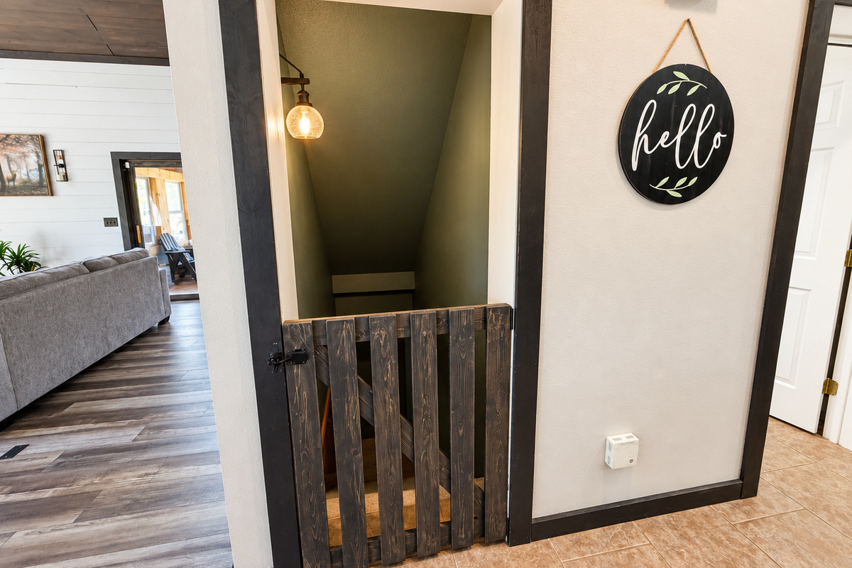 A convenient baby gate just off the kitchen helps keep little ones safe while still keeping the main living areas open, comfortable, and easy for families to enjoy together.