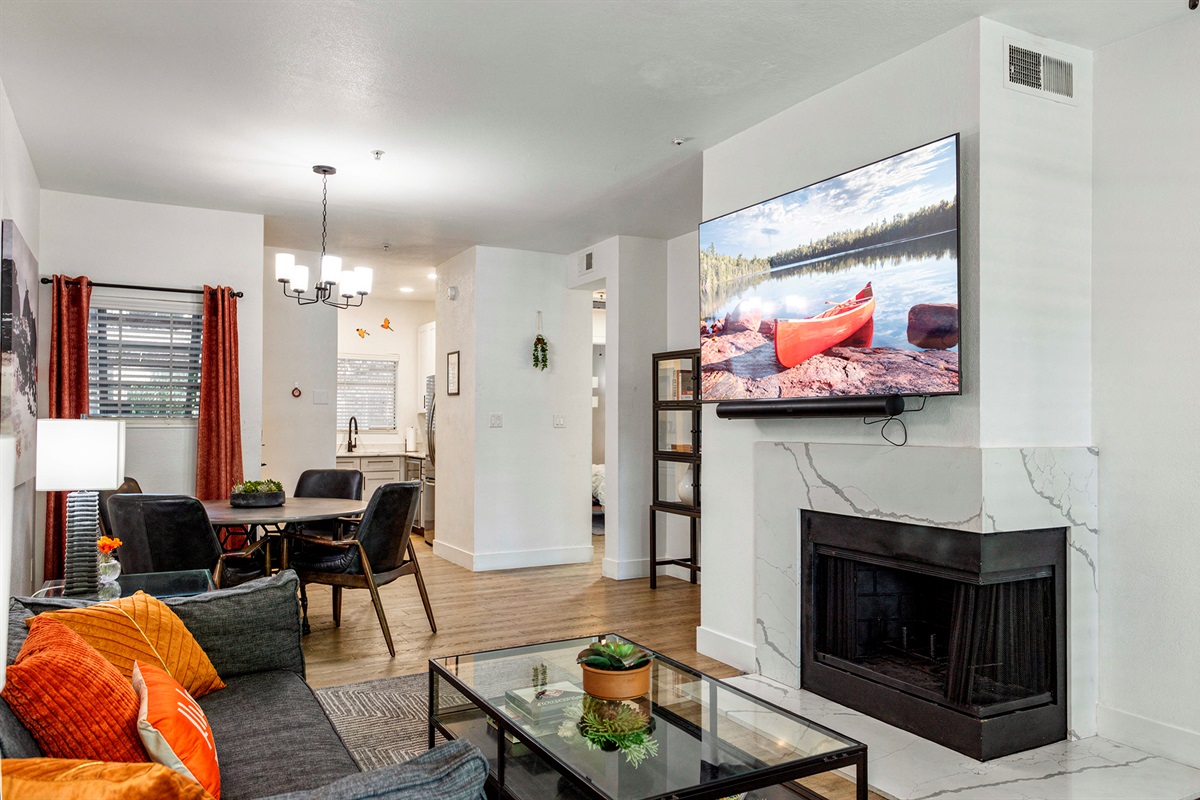 Enjoy a large smart TV, comfortable sofa seating, and plenty of natural light that gives the space an airy and relaxing feel.