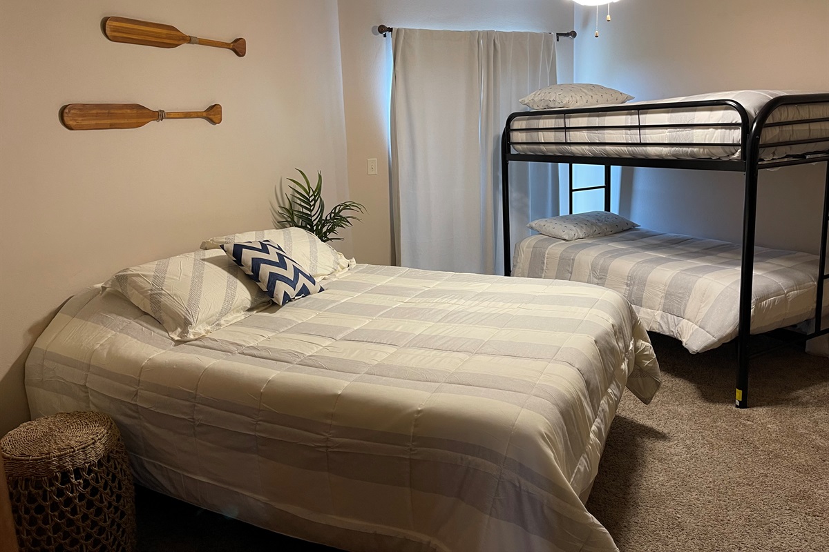 Guest room with queen bed and twin/twin bunk beds