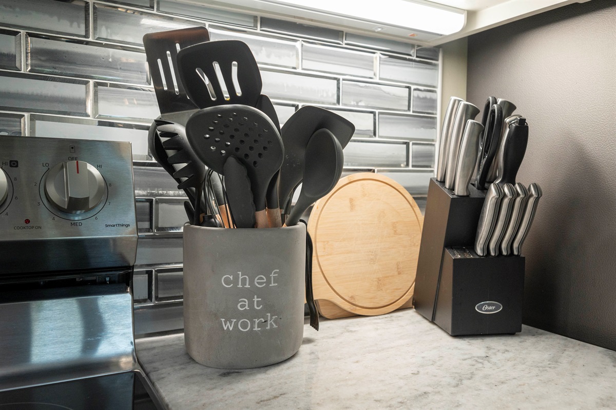 Chic kitchen corner with sleek utensils, knife set, and modern backsplash.