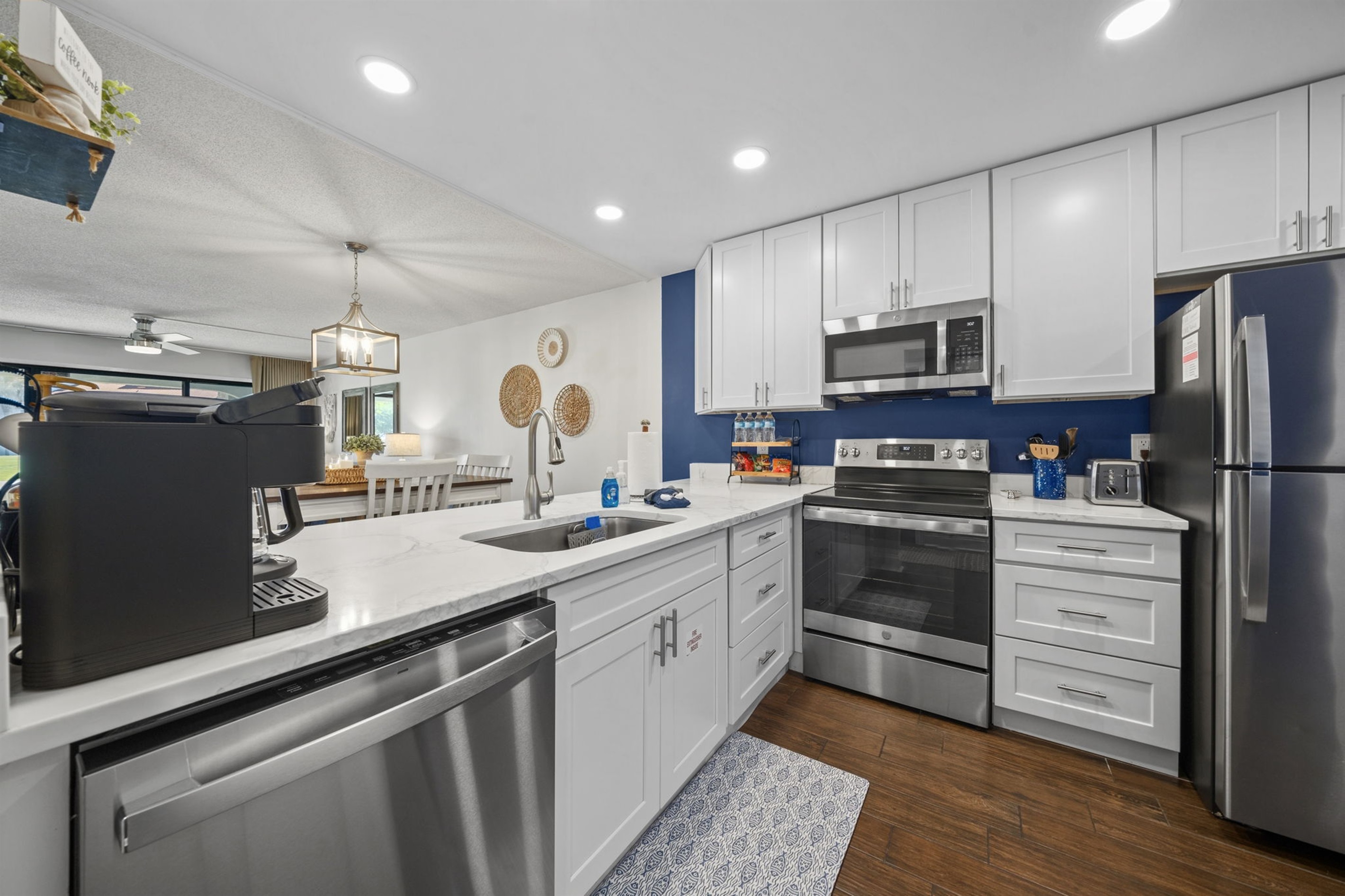 Updated, open modern kitchen with dishwasher, garbage disposal, oven, microwave and full size refrigerator
