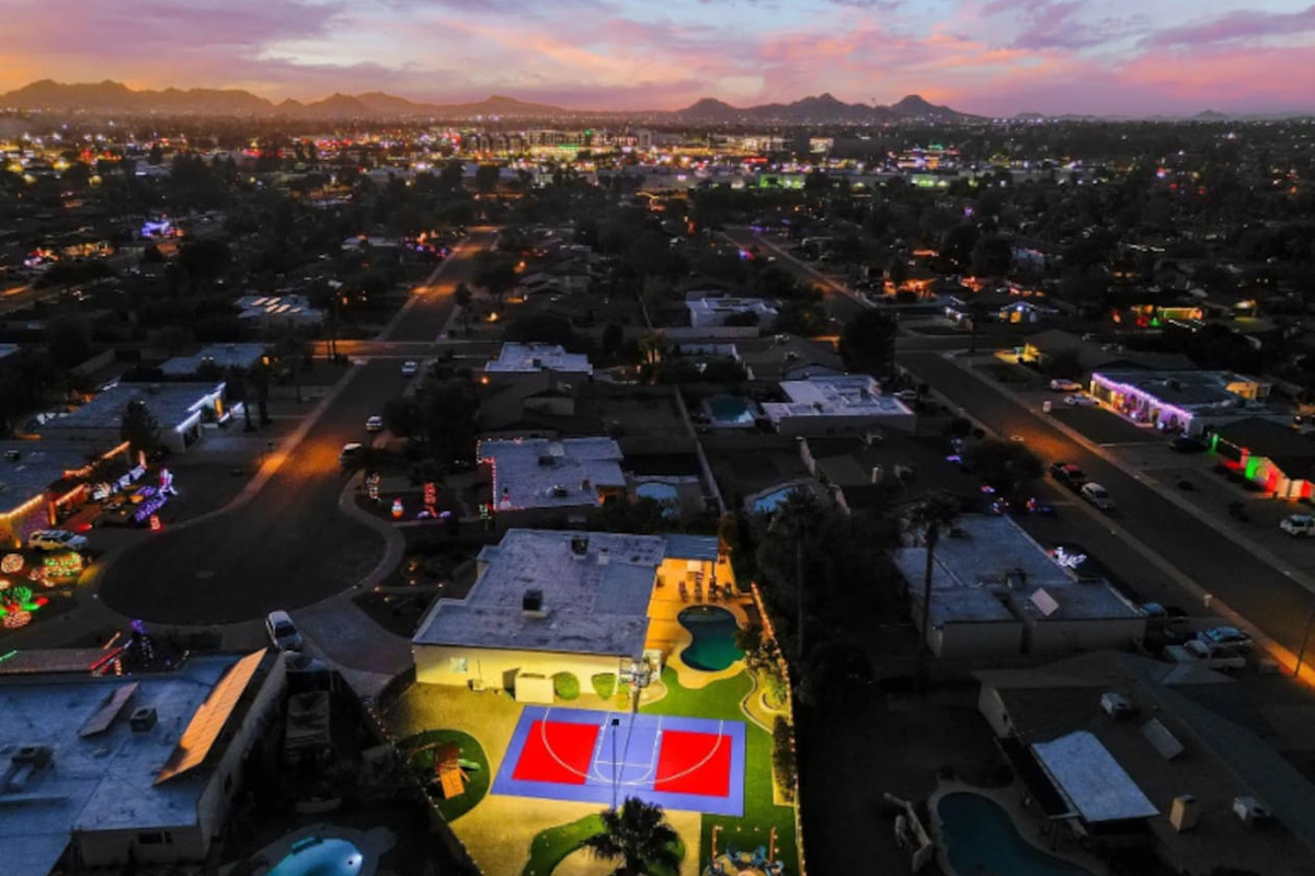 As the sky turns purple, the court lights take over — this backyard doesn't stop when the sun goes down.
