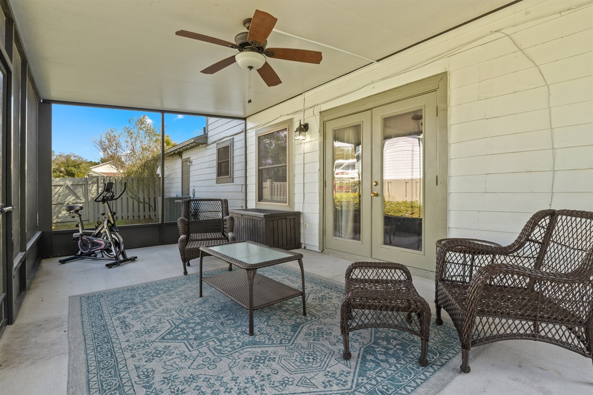 Interior living room door leads to exterior backyard screened in lanai.