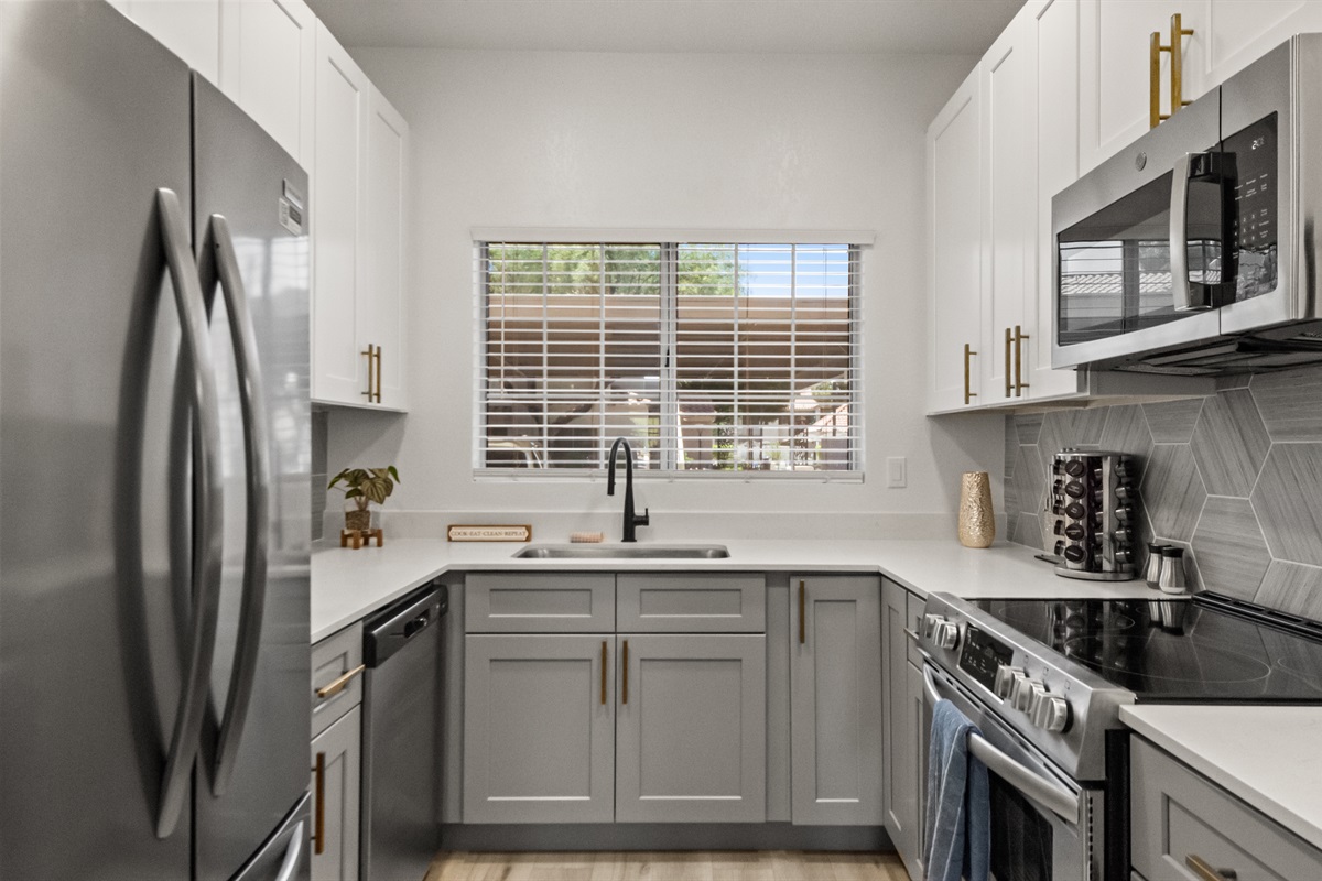 Bright and spacious kitchen with full-size appliances, cooking essentials, and plenty of prep space—perfect for preparing breakfast, family dinners, or meals during longer stays.