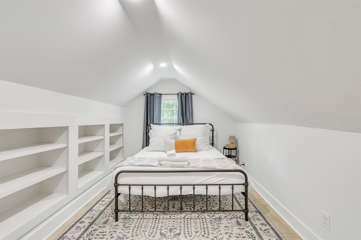 Quirky angled ceilings add character and charm to this cozy bedroom retreat