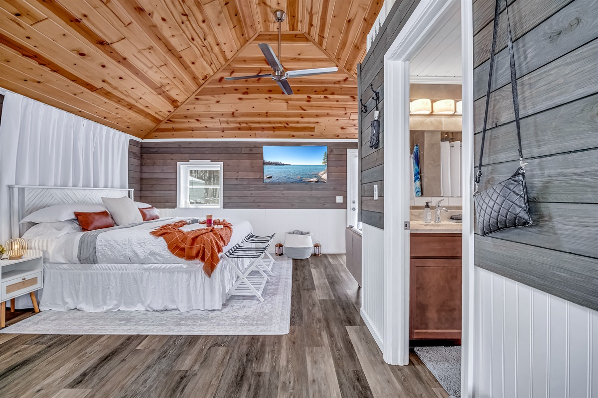 King bed with hotel quality linens, extra pillows and blankets as well as luggage racks for convenience.