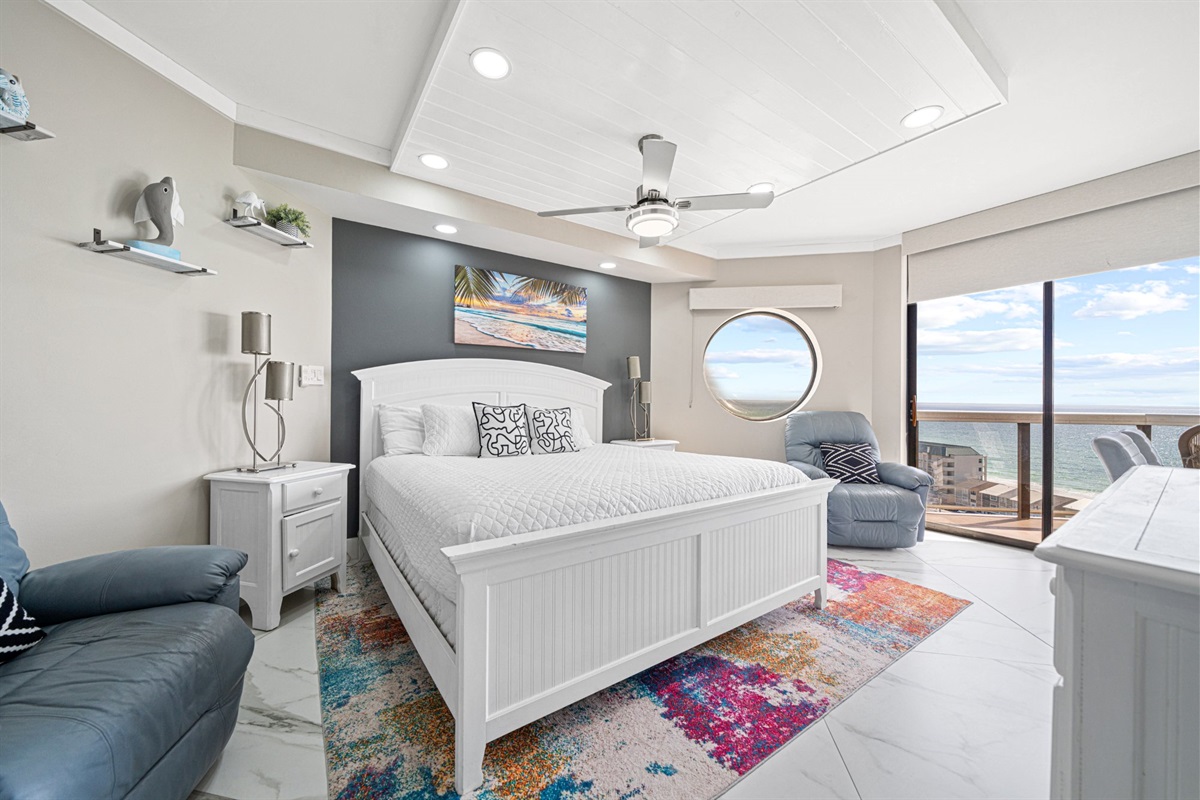 Wake up to the sound of the Gulf and open your eyes to this. The master bedroom features a king bed, a unique circular porthole window with direct Gulf views, and a private balcony slider to greet every morning in style.