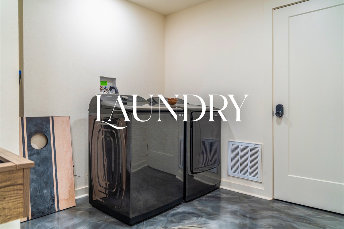 Laundry room with full washer and dryer for guest use.