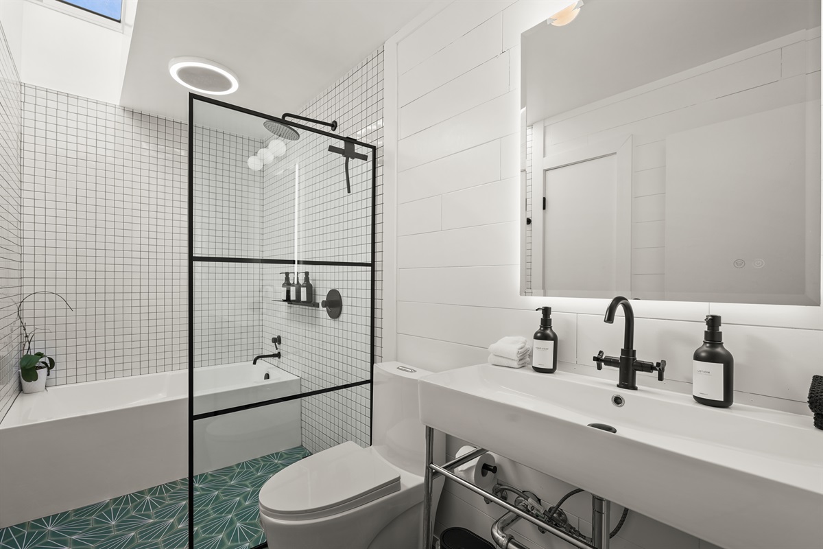 Well-appointed bathroom with a combination bathtub and walk-in shower, perfect for both a relaxing soak and a refreshing start to the day.