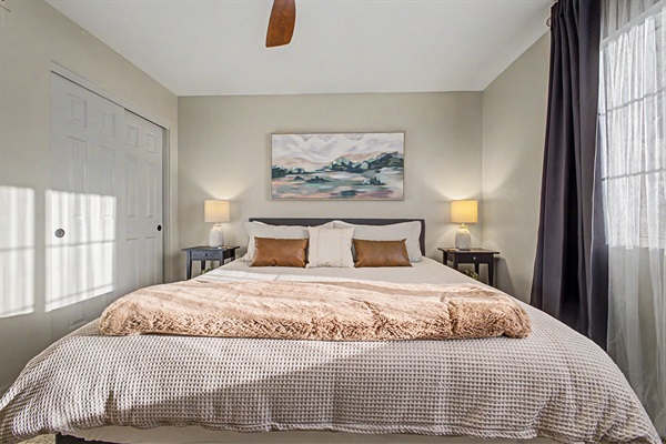 King bedroom 3 upstairs with 55" Smart TV, blackout curtains and ceiling fan