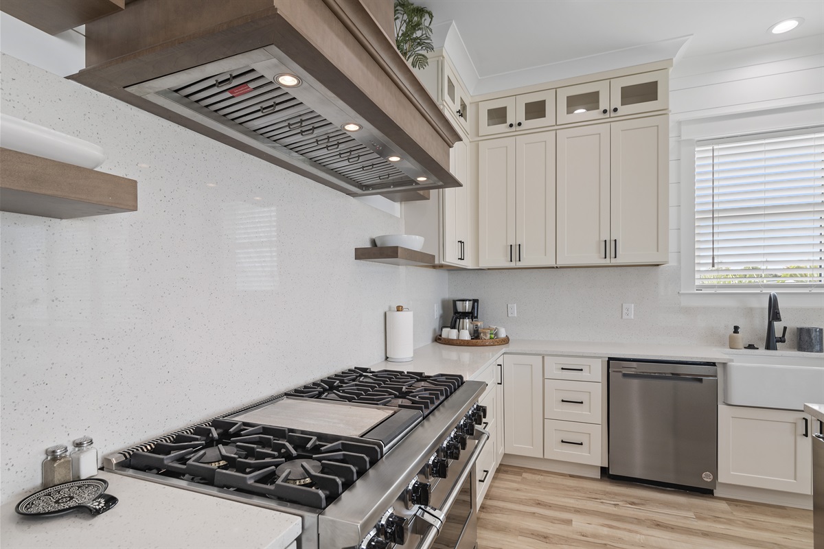 Fully equipped kitchen with a professional 48-inch range and built-in oven.
