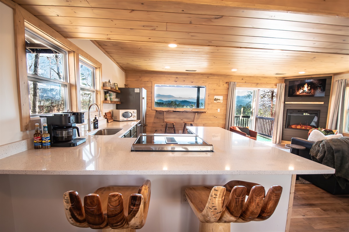 Bright & open living/dining area with custom bar hand chairs, mountain view coffee bar and large island for cooking and entertaining together!