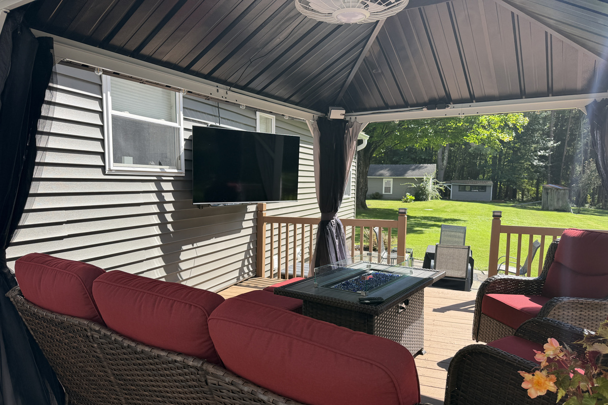 Back porch seating with outdoor SmartTV and gas fire table